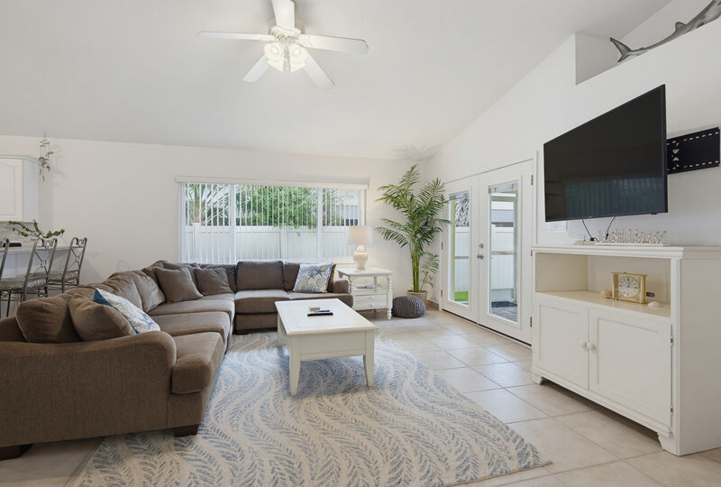 Living room opens to the lanai — the Lighthouse, New Smyrna Beach